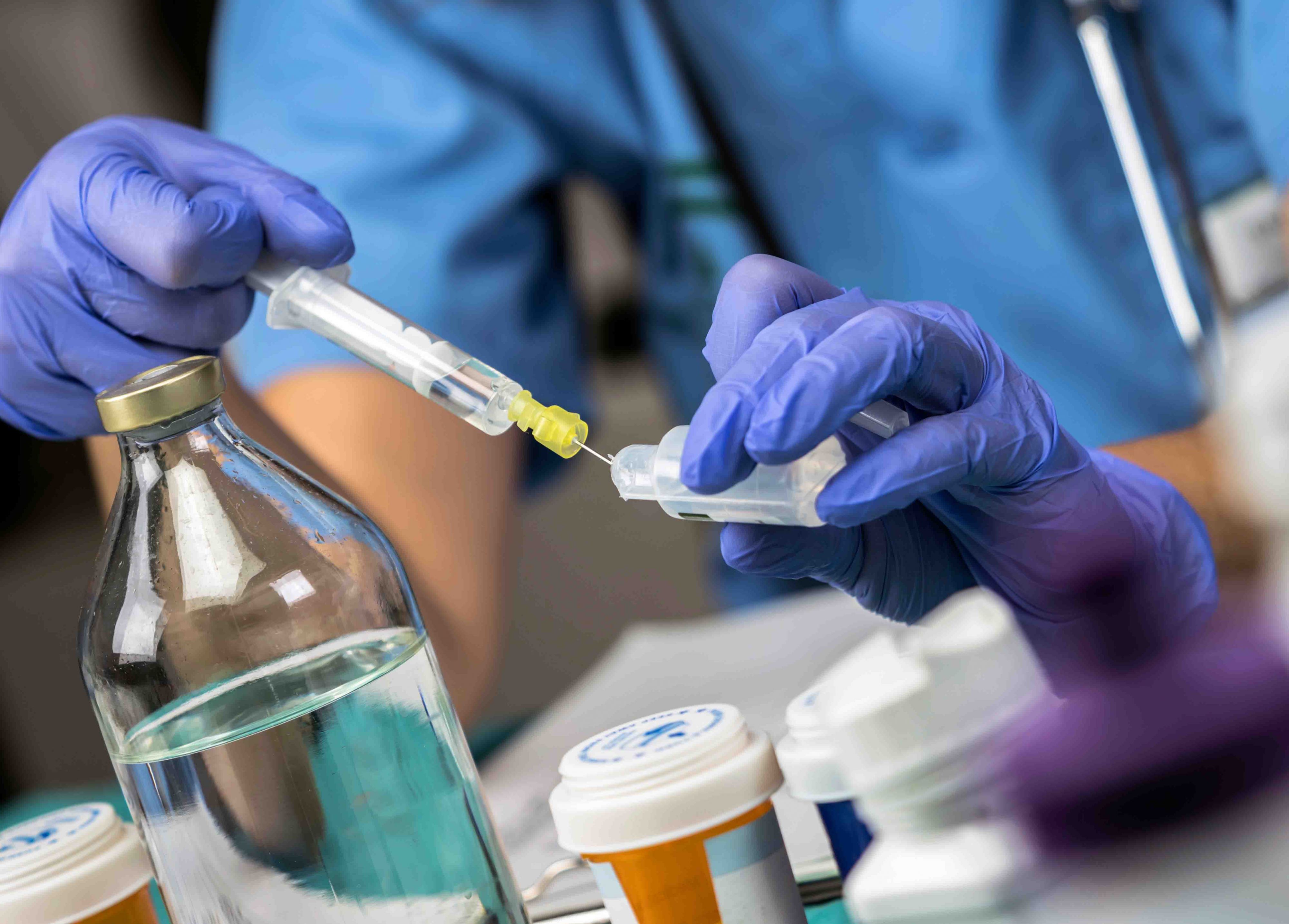 Nurse administering chemotherapy drugs