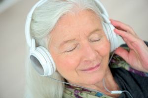 A woman listens to music to help with tinnitus.