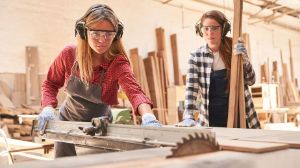 Two carpenters at work, wearing hearing protection.